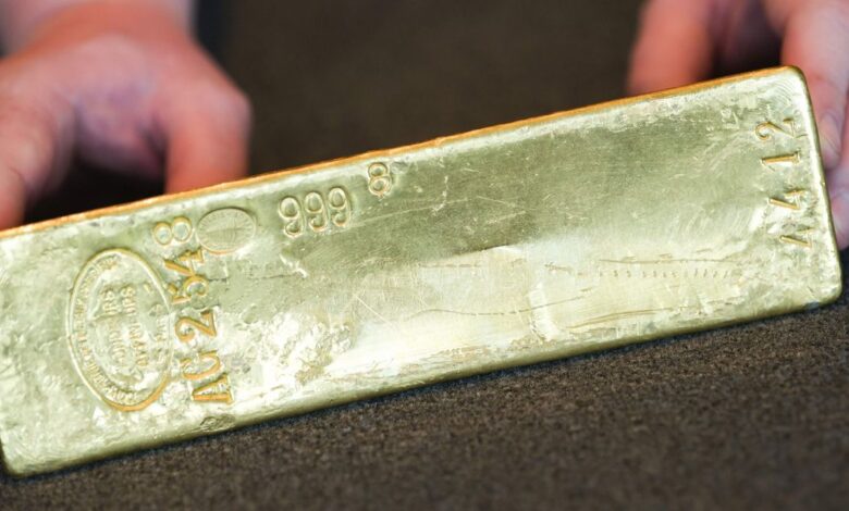 Gold taps its lowest price in more than 5 weeks as U.S. dollar rises