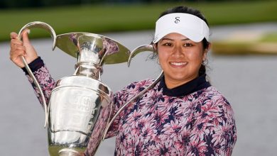 Lilia Vu celebrates with the trophy after her playoff win over Angel Yin to claim the Chevron Championship