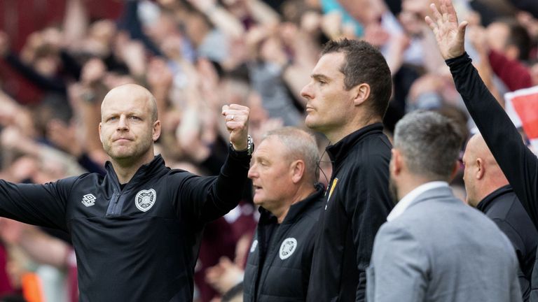 EDINBURGH, SCOTLAND - MAY 27: Hearts' interim manager Steven Naismith (L) celebrates the full-time whistle whilst Hibernian manager Lee Johsnon watches on after a cinch Premiership match between Heart of Midlothian and Hibernian at Tynecastle Park, on May 27, 2023, in Edinburgh, Scotland. (Photo by Mark Scates / SNS Group)